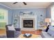 Comfortable living room features a brick fireplace, hardwood floors, and lots of light at 7 Hitching Rack Ct, Durham, NC 27713