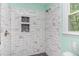 Modern shower with marble-look tiles, built-in niche, and decorative starfish at 7 Hitching Rack Ct, Durham, NC 27713