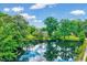 Aerial view of a property featuring a pond, surrounding trees, and beautiful landscaping at 750 Greenleaf Rd, Angier, NC 27501