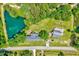 Aerial view of property with large pond and treed lot at 750 Greenleaf Rd, Angier, NC 27501