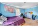 Bedroom with a colorful tapestry, large dresser, and lots of natural light at 750 Greenleaf Rd, Angier, NC 27501