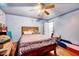 Cozy bedroom with wood floors, a ceiling fan, and bed at 750 Greenleaf Rd, Angier, NC 27501