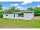 Exterior view of a house with white siding and a well-maintained lawn at 750 Greenleaf Rd, Angier, NC 27501