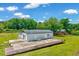 Back exterior view of the home showcasing the back of the home with a deck and spacious yard at 750 Greenleaf Rd, Angier, NC 27501