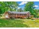 Beautiful brick house with a deck and a spacious green lawn at 750 Greenleaf Rd, Angier, NC 27501
