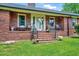 Inviting front entrance with brick steps leading to a cozy porch and chairs at 750 Greenleaf Rd, Angier, NC 27501
