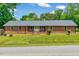 Charming brick home with a well-manicured lawn and inviting front porch at 750 Greenleaf Rd, Angier, NC 27501