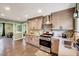 A bright kitchen boasts stainless steel appliances, including a range hood and mosaic backsplash at 750 Greenleaf Rd, Angier, NC 27501