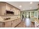 A stylish kitchen with sleek countertops, stainless steel microwave, and warm-toned cabinetry at 750 Greenleaf Rd, Angier, NC 27501