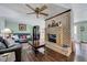 Cozy living room with a brick fireplace, comfortable seating, and hardwood floors at 750 Greenleaf Rd, Angier, NC 27501