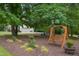 Backyard featuring a swing, comfortable seating, and lush landscaping, perfect for relaxation at 750 Raymond Dr, Clayton, NC 27527
