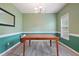 Green dining room with decorative mirror and grey hardwood floors at 750 Raymond Dr, Clayton, NC 27527