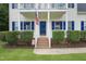 Inviting front entrance with American flag, hanging flower baskets, and manicured shrubbery at 750 Raymond Dr, Clayton, NC 27527