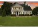 Inviting two-story home with a manicured lawn, traditional design, and cozy front porch at 750 Raymond Dr, Clayton, NC 27527