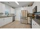 Bright kitchen featuring stainless steel appliances, granite countertops, and ample cabinet space at 750 Raymond Dr, Clayton, NC 27527