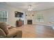 Bright living room featuring hardwood floors, a fireplace, and large windows at 750 Raymond Dr, Clayton, NC 27527
