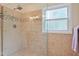 Elegant tiled shower featuring glass surround, mosaic accents, and rainfall shower head at 750 Raymond Dr, Clayton, NC 27527