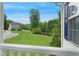 Lush green lawn with trees and a view of the two-story home from the porch at 750 Raymond Dr, Clayton, NC 27527