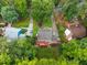 Aerial view showcasing a private residence with mature trees surrounding a manicured lawn at 7520 Milestone Ct, Raleigh, NC 27615