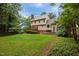 Spacious backyard featuring a well-maintained lawn, wooden deck, and lush landscaping at 7520 Milestone Ct, Raleigh, NC 27615