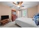 A bright bedroom with a ceiling fan, carpet and a TV sitting on a wooden dresser at 7520 Milestone Ct, Raleigh, NC 27615