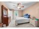 A bright bedroom with a ceiling fan, plush carpet and a quaint writing desk at 7520 Milestone Ct, Raleigh, NC 27615