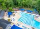 Aerial shot of a community pool area with plenty of seating, umbrellas, and clubhouse at 7520 Milestone Ct, Raleigh, NC 27615