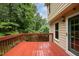 Cozy outdoor deck area with natural light and a view of lush greenery at 7520 Milestone Ct, Raleigh, NC 27615