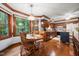 Inviting dining area and kitchen combination, featuring wood furniture and large windows with views to the exterior at 7520 Milestone Ct, Raleigh, NC 27615
