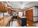 Functional kitchen with stainless appliances, wooden cabinets, and a versatile kitchen island at 7520 Milestone Ct, Raleigh, NC 27615
