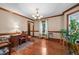 Elegant living room with hardwood floors, decorative moldings, and ample natural light at 7520 Milestone Ct, Raleigh, NC 27615