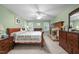 Cozy main bedroom with a brick fireplace, carpeted floors, and wood furnishings at 7520 Milestone Ct, Raleigh, NC 27615