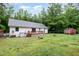 Home exterior displaying a spacious, chain-linked fenced-in backyard with a storage shed and wood deck at 7603 Nichols Dr, Rougemont, NC 27572
