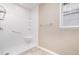All-white shower with a built-in seat and handrails for accessibility and safety at 7603 Nichols Dr, Rougemont, NC 27572