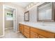 Bathroom featuring double sinks with white countertops and wood cabinets at 7603 Nichols Dr, Rougemont, NC 27572