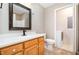 Well-lit bathroom featuring a vanity with ample storage space and a separate laundry area at 7603 Nichols Dr, Rougemont, NC 27572