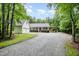 Charming home featuring a large front yard, a detached two-car garage, and an attached carport at 7603 Nichols Dr, Rougemont, NC 27572