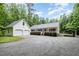 Charming home featuring a large front yard, a detached two-car garage, and an attached carport at 7603 Nichols Dr, Rougemont, NC 27572