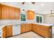 Bright kitchen with wood cabinets, white countertops, white appliances, and tiled backsplash at 7603 Nichols Dr, Rougemont, NC 27572