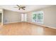 Bright living room featuring laminate flooring, neutral paint, and a large window at 7603 Nichols Dr, Rougemont, NC 27572