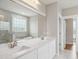 Bright bathroom featuring double sinks, a large mirror, a soaking tub, and a walk-in shower at 7719 Barefoot Rd, Fuquay Varina, NC 27526