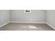 Compact bedroom featuring neutral tones, carpet, and a small window that provides natural light at 7719 Barefoot Rd, Fuquay Varina, NC 27526