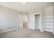 Bright bedroom features carpet, closet, and two doors leading to other parts of the home at 7719 Barefoot Rd, Fuquay Varina, NC 27526
