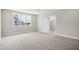 Neutral bedroom with carpet, large window, and an open doorway that creates an inviting, spacious feel at 7719 Barefoot Rd, Fuquay Varina, NC 27526