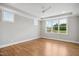 Spacious bedroom with hardwood floors, large windows offering views, and a ceiling fan at 7719 Barefoot Rd, Fuquay Varina, NC 27526