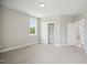 Bedroom with neutral carpet, a window with outdoor views, and closet shelving at 7719 Barefoot Rd, Fuquay Varina, NC 27526