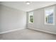 This bedroom has two windows that allow natural light to flood the space, highlighting its simple design at 7719 Barefoot Rd, Fuquay Varina, NC 27526
