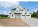 New two-story home featuring white siding, a black roof, attached garage, and a neatly paved driveway at 7719 Barefoot Rd, Fuquay Varina, NC 27526