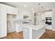 Bright kitchen featuring white cabinets, stainless steel appliances, and a spacious center island at 7719 Barefoot Rd, Fuquay Varina, NC 27526