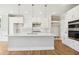 Well-lit kitchen with white cabinets, stainless appliances, and a large center island at 7719 Barefoot Rd, Fuquay Varina, NC 27526